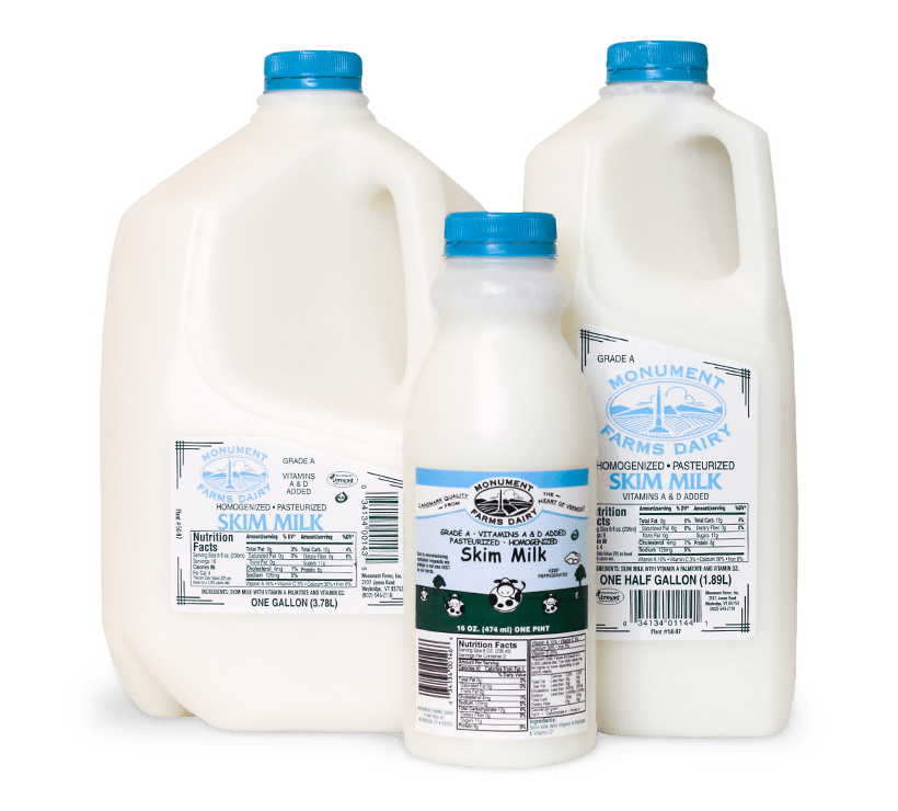 A pint, half gallon, and gallon jug of Monument Farms local skim milk.