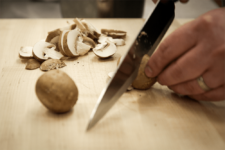 Mushrooms being diced. Step one in the Champagne Chicken recipe shared by the chefs at Fire and Ice Restaurant as one of their local Vermont recipes made with Monument fresh local heavy cream.