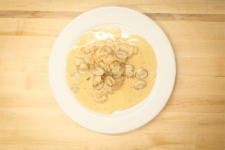 A delicious plate of chicken and mushrooms in a creamy champagne sauce, created by the chefs at Fire and Ice Restaurant as one of their local Vermont recipes made with Monument fresh local heavy cream.