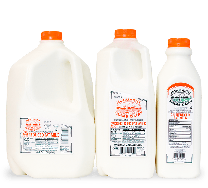 A quart, half gallon, and gallon jug of Monument Farms local 2% milk.