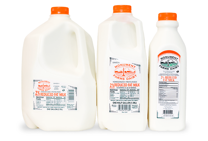 A quart, half gallon, and gallon jug of Monument Farms local 2% milk.