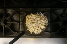 Cavatappi pasta added to sauce and tossed until evenly coated. Step eight in the Cavatappi Carbonara recipe shared by the chefs at Leunig's Bistro as one of their local Vermont recipes made with Monument fresh local heavy cream.