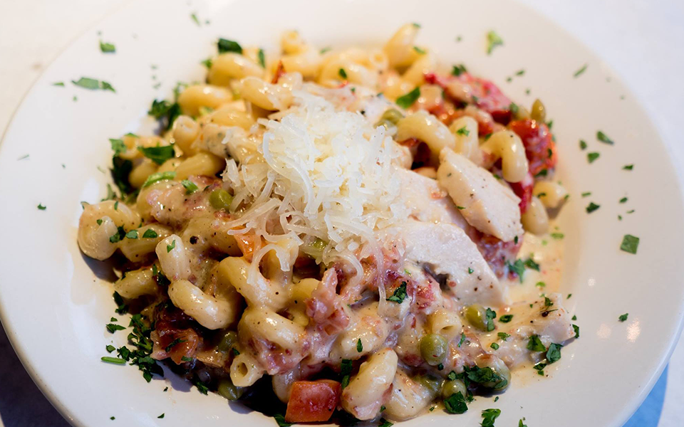 A delicious plate of pasta in a creamy sauce, created by the chefs at Leunig's Bistro as one of their local Vermont recipes made with Monument fresh local heavy cream.