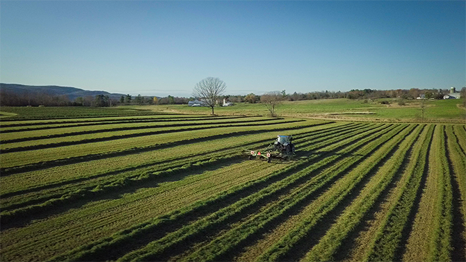 A tractor tends the field on the Monument Dairy Farm where they produce fresh Vermont milk