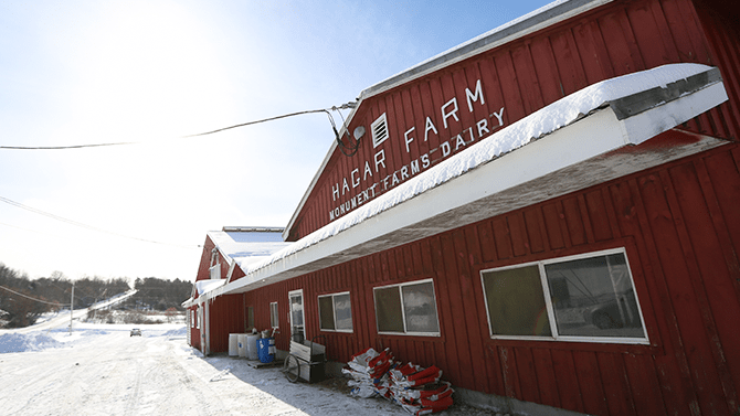 A front view of the Hagar Farm at Monument Farms Dairy where you can schedule a Vermont farm tour.